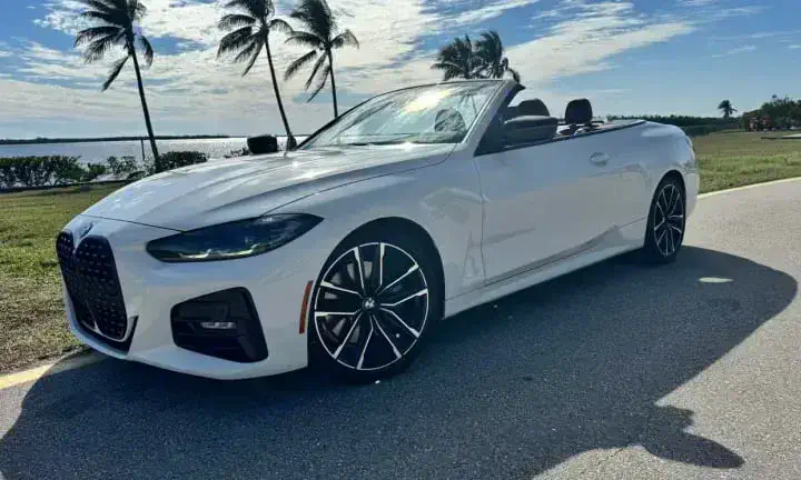 2023 BMW 430i convertible rental vehicle in white, top down, Southwest Florida coastline