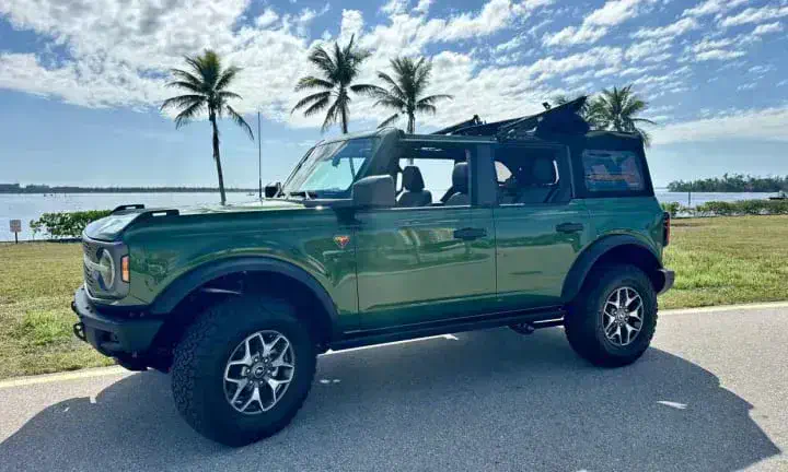 2024 Ford Bronco rental vehicle in green, top off, Southwest Florida coastline